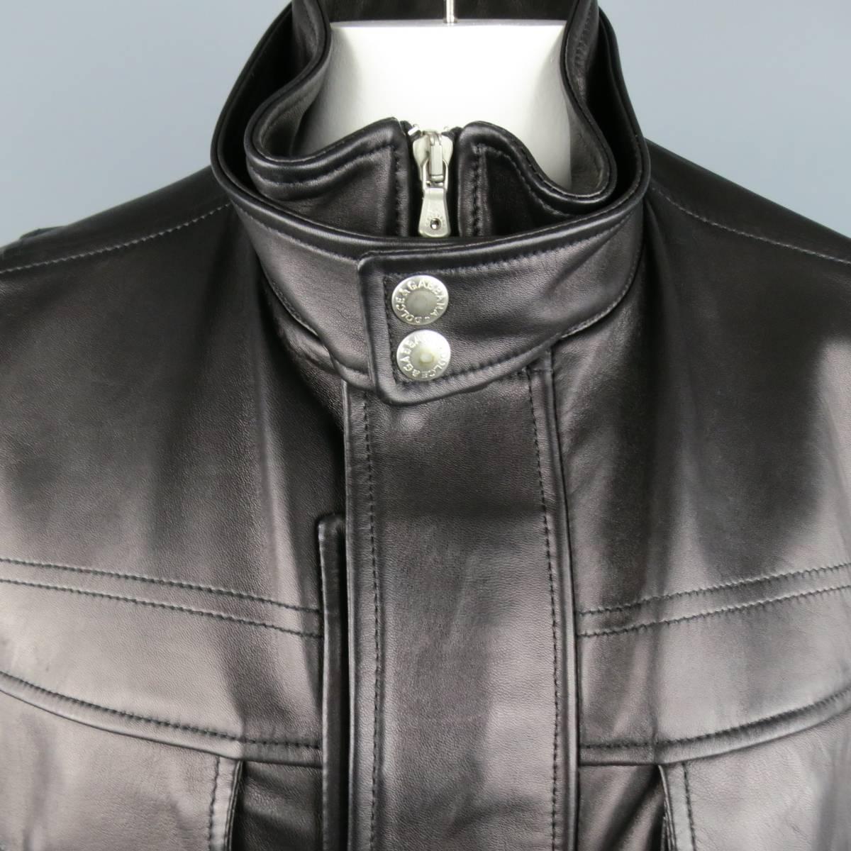 DOLCE & GABBANA jacket in a smooth black leather featuring a high collar with snap band, double hidden placket zip and snap closure, patch flap breast pockets, slanted pockets, back tabs, and snap cuffs. Made in Italy.
 
Excellent Pre-Owned