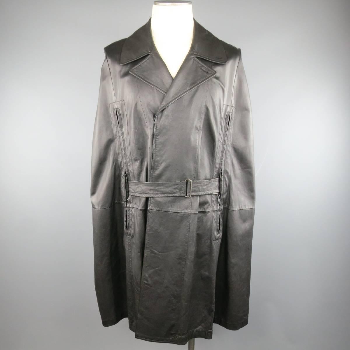Rare ANN DEMEULEMEESTER cape in a  light weight smooth black leather featuring a classic pointed lapel, hidden placket double breasted closure, and double zip frontal slits with belt. Made in Italy.
 
Excellent Pre-Owned Condition.
Marked: SXX
