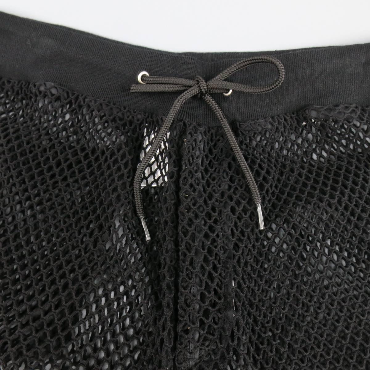 MOSCHINO shorts in a black cotton blend fishnet mesh featuring a ribbed drawstring waistband, zip fly, back patch pockets, and trim details.
 
New with Tags. Retails at $405.00.
Marked: IT 46
 
Measurements:
 
Waist: 32 in.
Rise: 14 in.
Inseam: 9 in.