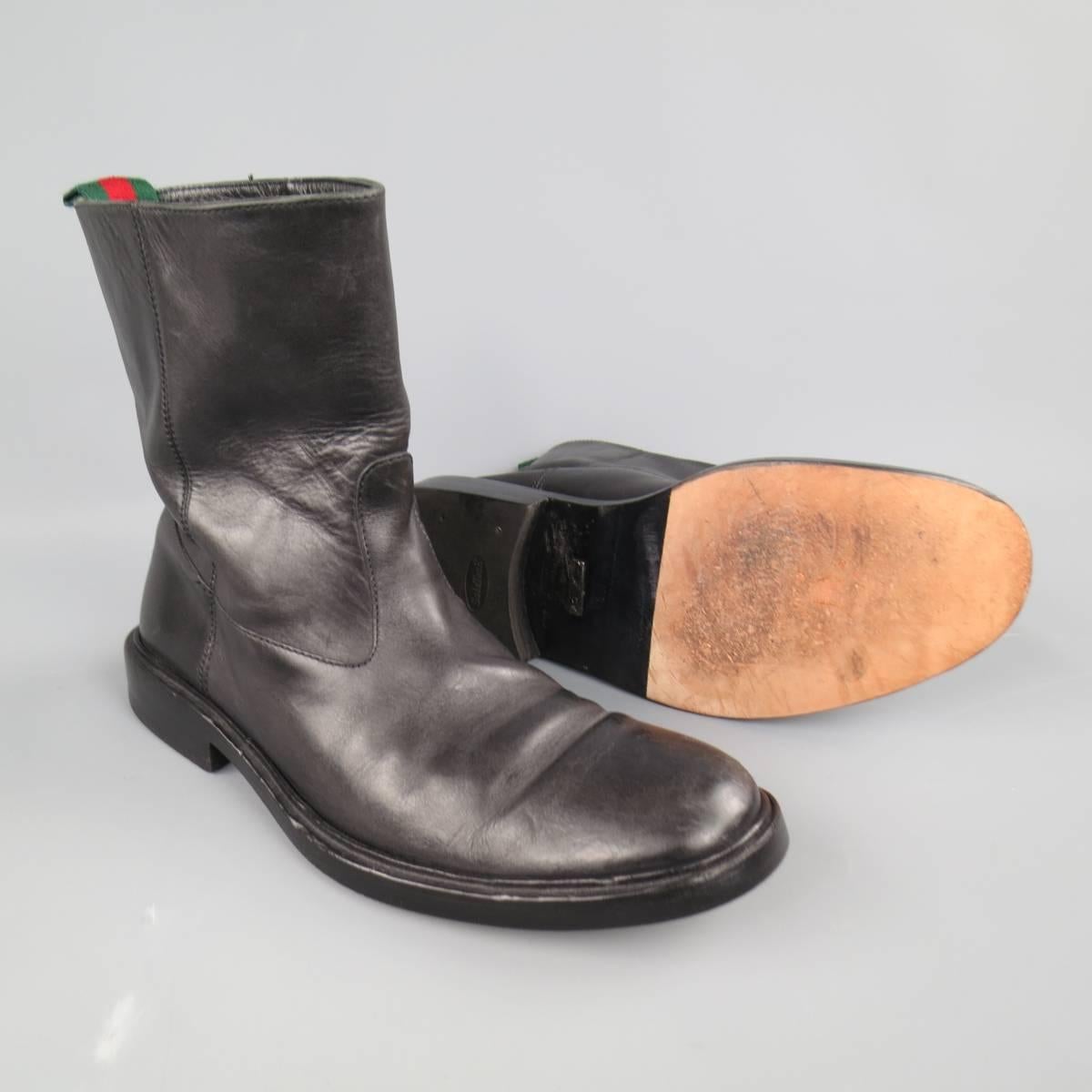 Classic GUCCI pull on biker style boots in black leather featuring a round toe,medium  tall shaft, and signature green and red striped webbing pull tab on back. Made in Italy.
 
Good Pre-Owned Condition.
Marked: UK 10 D
 
Outsole: 12.75 x 4.75