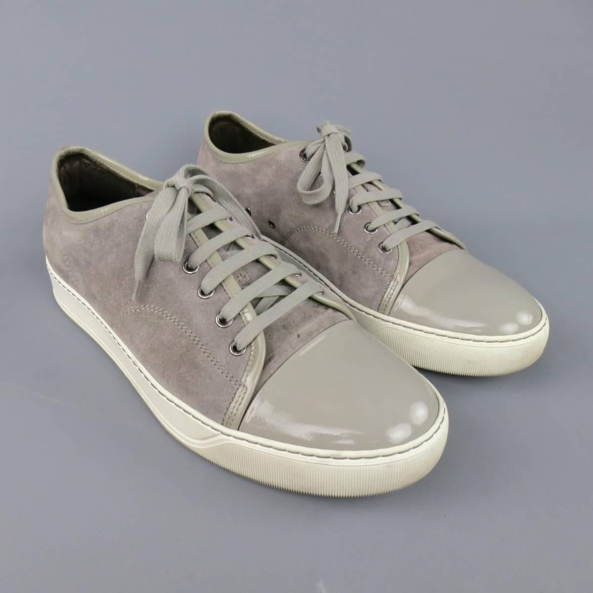 Classic LANVIN sneakers in silver gray suede featuring a patent leather toe cap and piping with a thick white rubber sole. With Box. Made in Portugal.
 
Excellent Pre-Owned Condition.
Marked: UK 9
 
Outsole: 12 x 4.45 in.