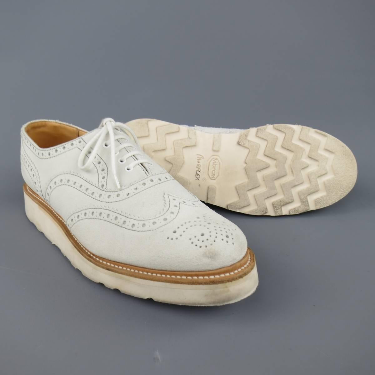HERITAGE RESEARCH brogues in an off white suede featuring a round toe with wingtip, perforated brogue details throughout, and thick Vibram sole. Wear throughout. Made in  England.
 
Good Pre-Owned Condition.
Marked: UK 8
 
Outsole: 12 X 4 in.
Sole: