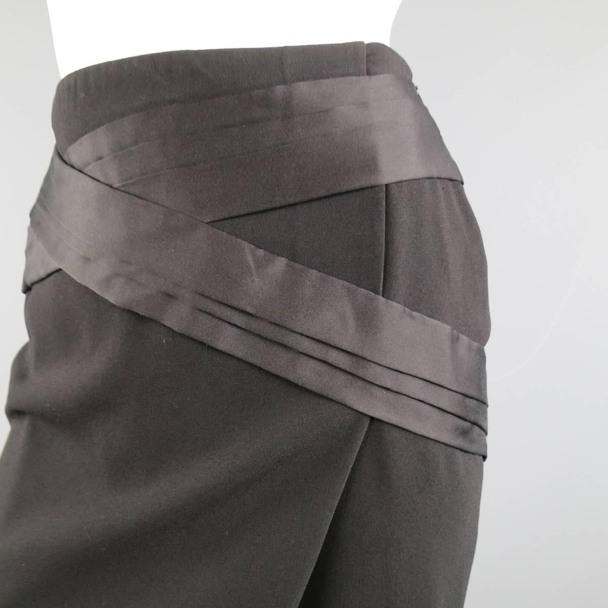 BALENCIAGA pencil skirt in a light weight black stretch crepe and features a side slit wrap front, and pleated satin applique panels. Made in France.
 
Excellent Pre-Owned Condition
Marked: 36
 
Measurements:
 
Waste: 27 In.
Hip: 34 In.
Length: 19