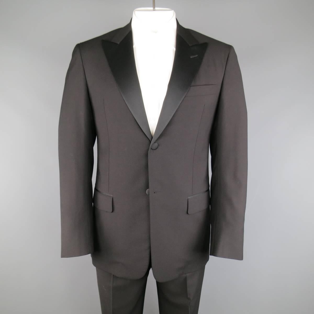 Classic VALENTINO tuxedo in a light weight black wool includes a two button jacket with half satin peak lapel and functional button cuffs with a matching pair of trousers with thick satin waistband and internal brace suspender buttons. Made in