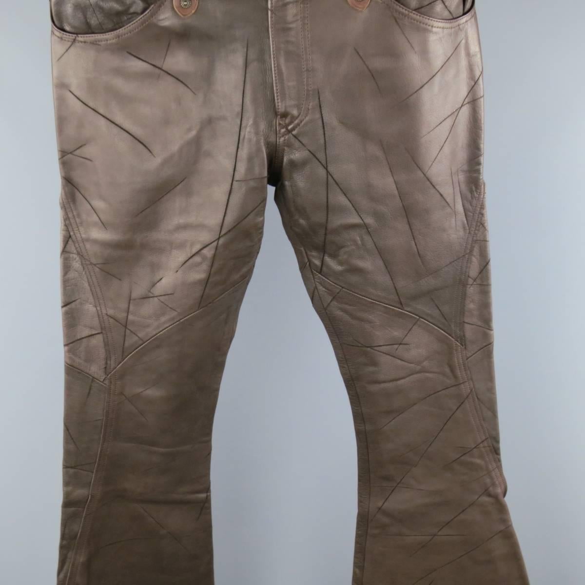 OBELISK Casual Pants consists of 100% leather material in a brown color tone. Designed with a zip-fly, button closure, side quarter pocket. Western style. Detailed cuts throughout legs with light brown trim. Wear throughout. Faint odor. As-Is. Made