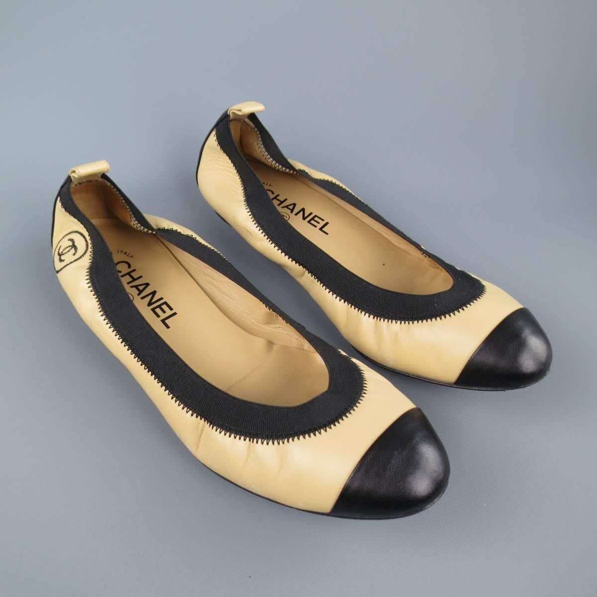 CHANEL beige and black leather toe cap ballet flats feature an elasticized topline, and signature embroidered 'CC
