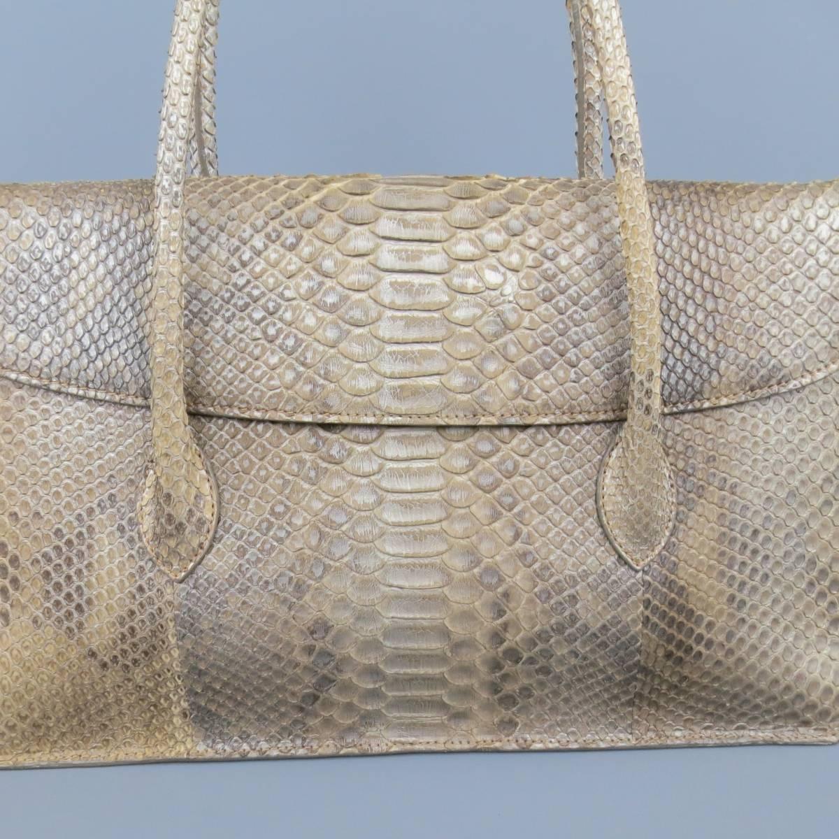 ALAIA shoulder bag in beige python skin leather with silver hues throughout features flap closure with snap. Inside features a divider middle pocket with zip closure, multiple compartment pockets throughout. Lined in a warm beige leather. Includes