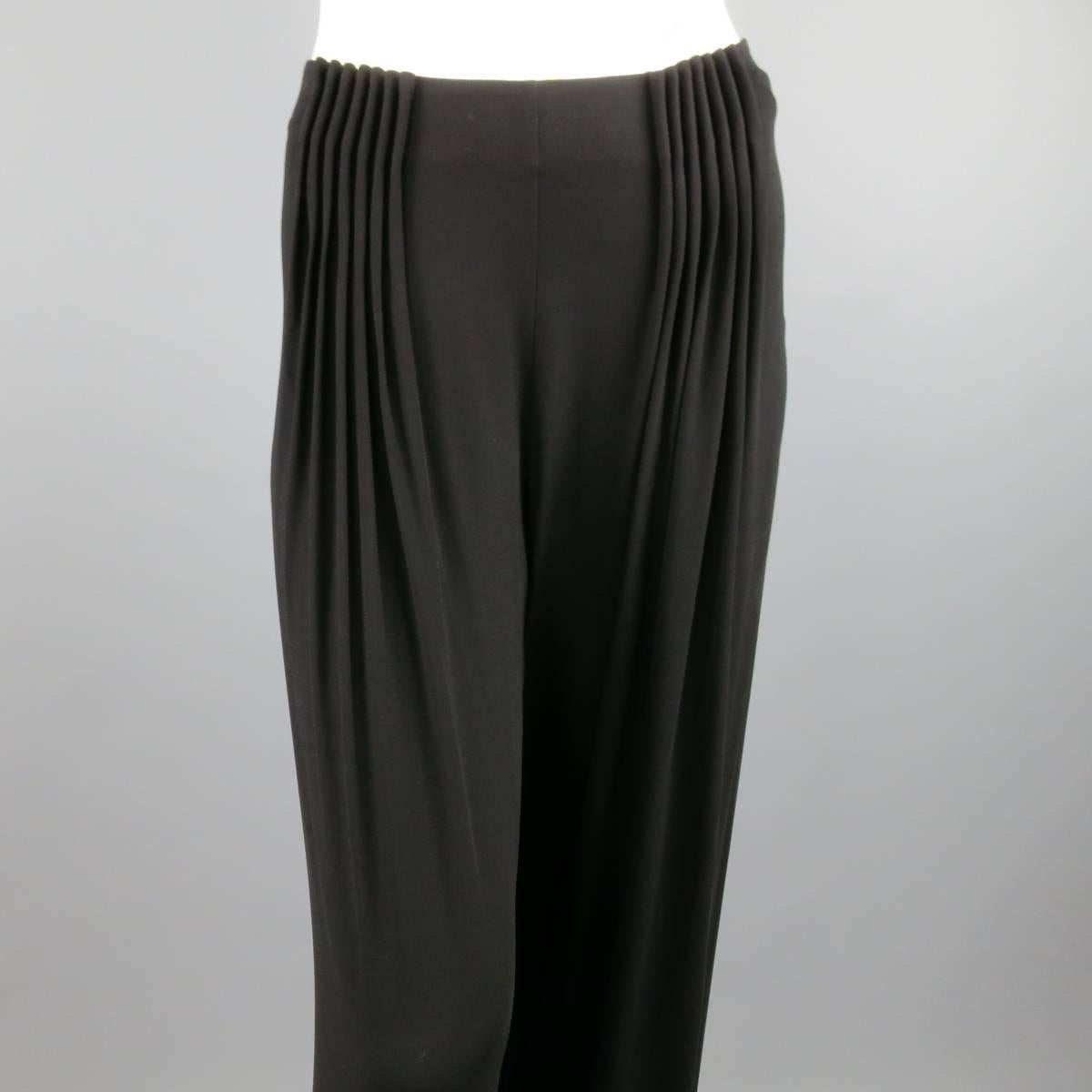 FENDI black rayon dress pants feature a wide leg with gathered pleats in the front with side zipper and hook and eye closure. Made in Italy.
Excellent Pre-Owned Condition.
Marked: 40
 
Measurements:
Waist: 32 In.
Rise: 9.5 In.
Inseam: 34 In.
