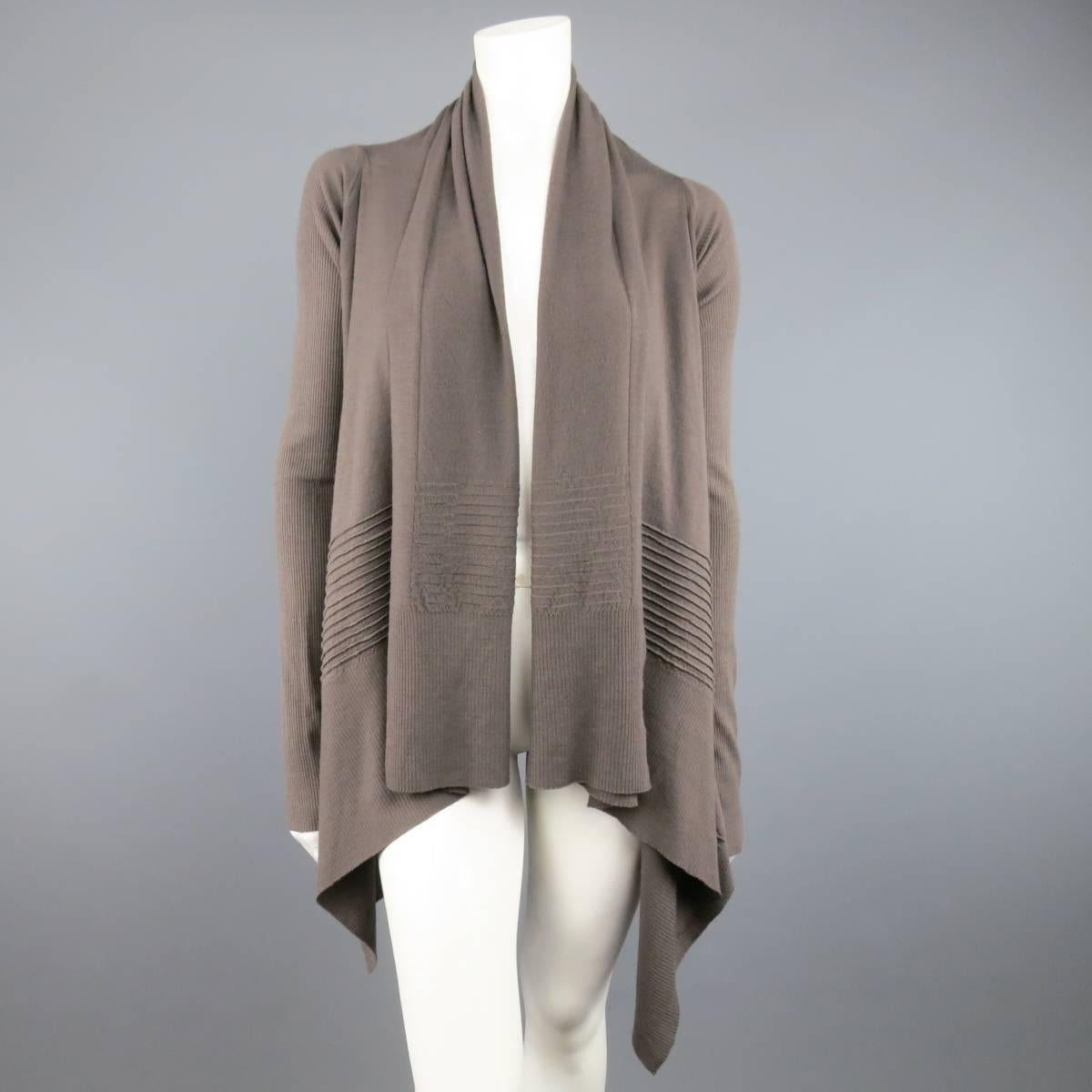 RICK OWENS taupe knitted cardigan features a shawl collar, open front, ribbed details and ribbed long sleeves. S/S 2013 Collection. Good Pre-Owned Condition.
Marked: Missing size tag.
 
Measurements:
Shoulders: 16.5 In.
Sleeve: 29.5 In.
Length: 29