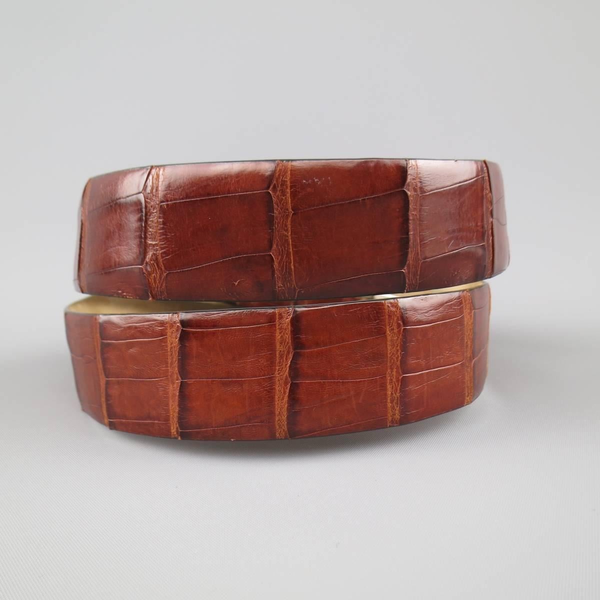 Vintage WILKES BASHFORD dress belt features a warm brown crocodile leather strap with light nubuck liner and silver tone buckle. Internal wear and scuff on loop. Made in Italy.
 
Good Pre-Owned Condition.
Marked: 85/32
 
Measurements:
 
Length: 40