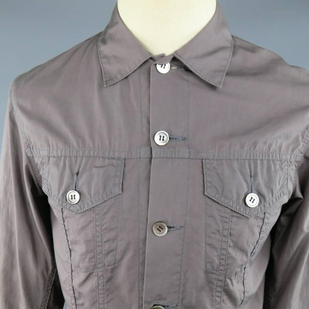 JUNYA WATANABE Jacket consists of cotton material in a taupe color tone. Designed in a button up front, chest pockets with button closure and tone-on-tone stitching throughout body. Single button cuffs and adjustable waist tabs. Made in Japan. Circa
