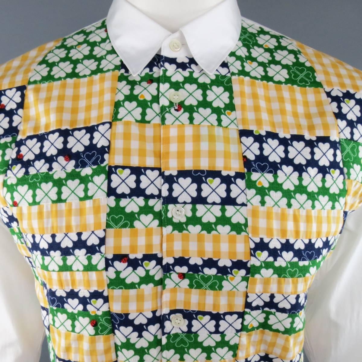 New with Tags COMME des GARCONS Long Sleeve Shirt consists of cotton material in a white and multi-color tone. Designed with a slim pointed collar, button up front and abstract pattern. Detailed with gingham and clover print in green, yellow and