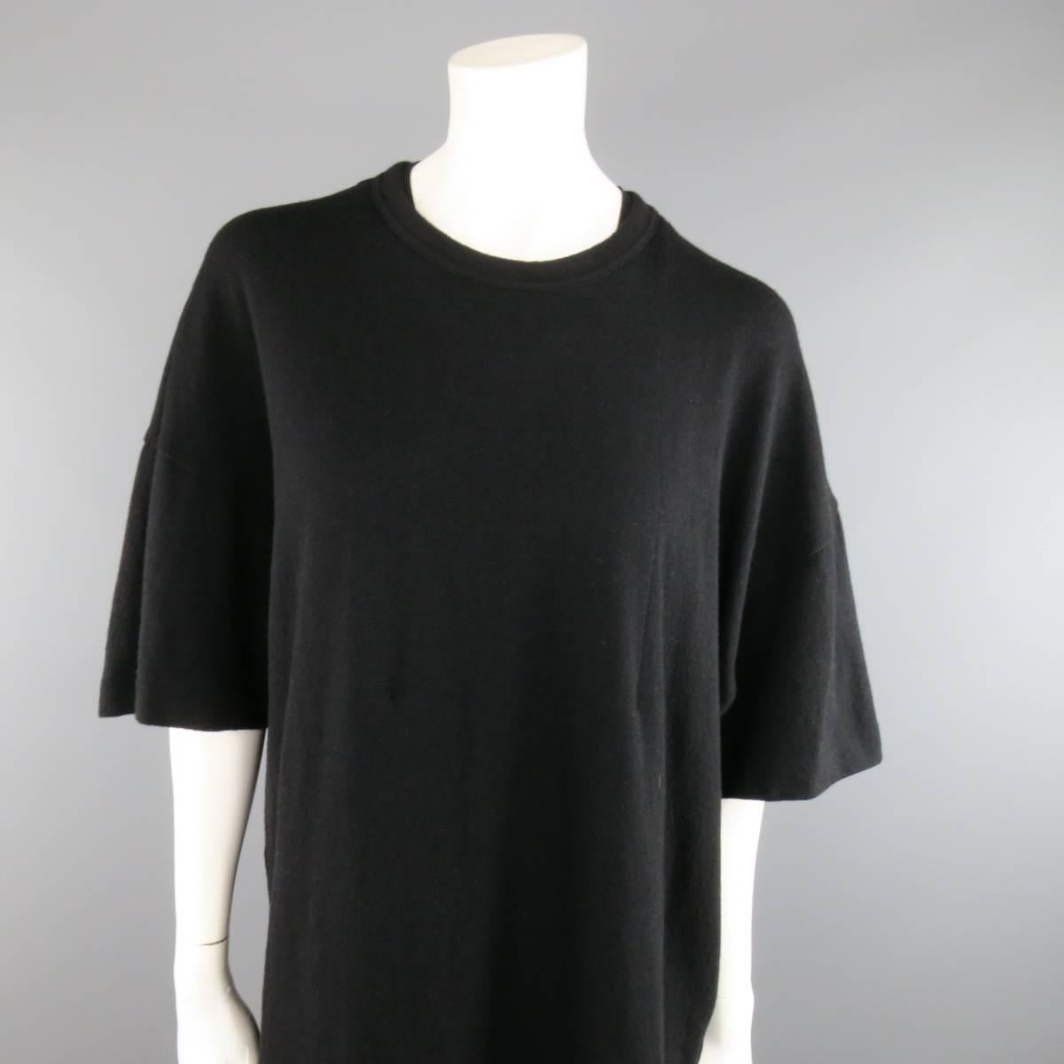 COMME des GARCONS T-Shirt consists of wool blend material in a black color tone. Designed in a double layered, crew-neck collar and short sleeve cuffs. Oversize style with an elongated underlay in a see-through polyester fabric.  Made in