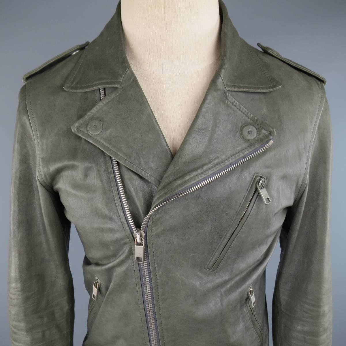 MARC JACOBS biker jacket in a distressed washed look leather featuring a pointed lapel, zip closure, epaulets with hidden snap closure, slanted zip pockets, zip cuffs and heather gray jersey liner. Wear throughout and minor smoke smell. As-Is. Made