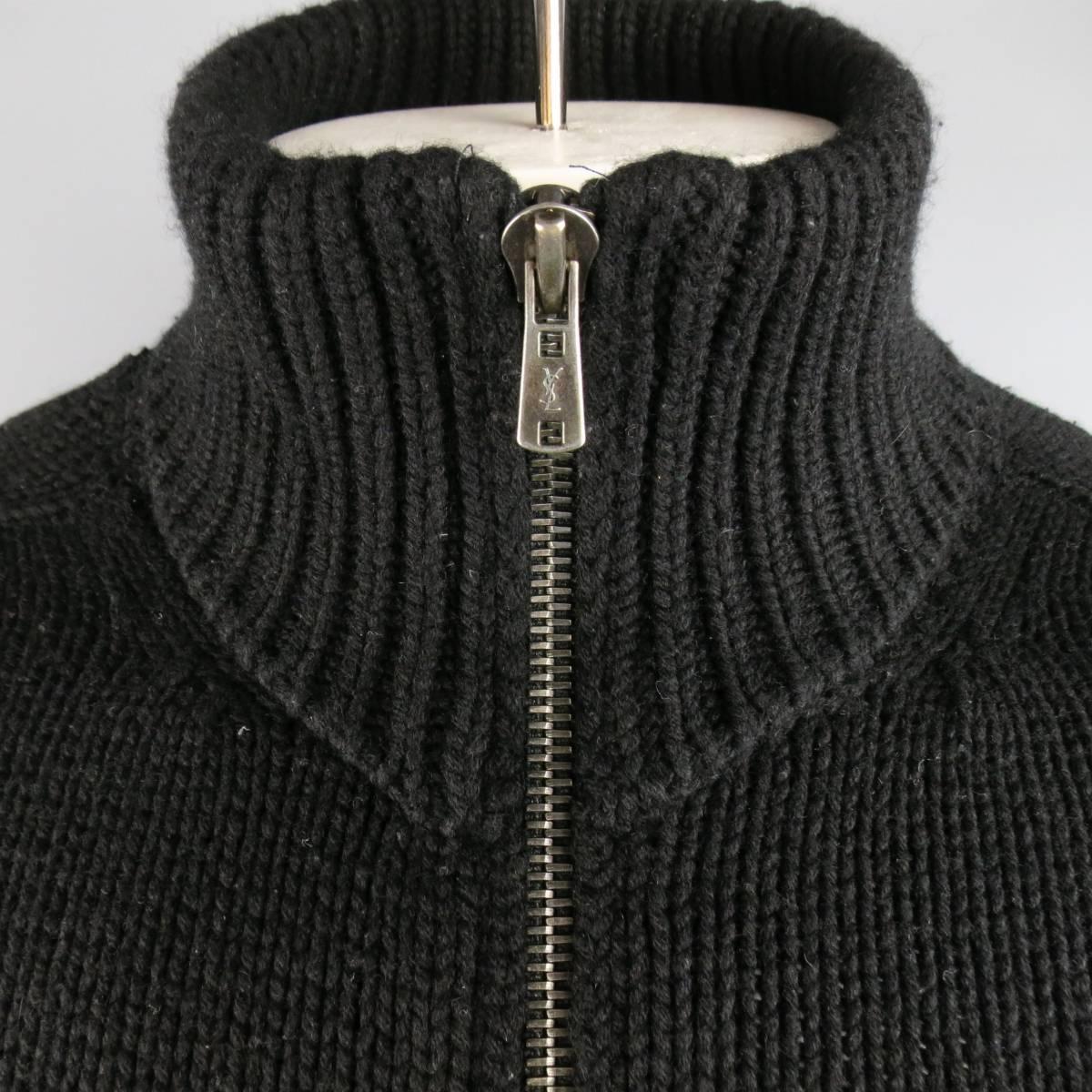 YVES SAINT LAURENT cardigan jacket comes in a thick cashmere knit and features a high, folded collar and dark silver tone gray zip up front. Wear throughout. Made in Italy.
 
Good Pre-Owned Condition.
Marked: M
 
Measurements:
 
Shoulder: 17