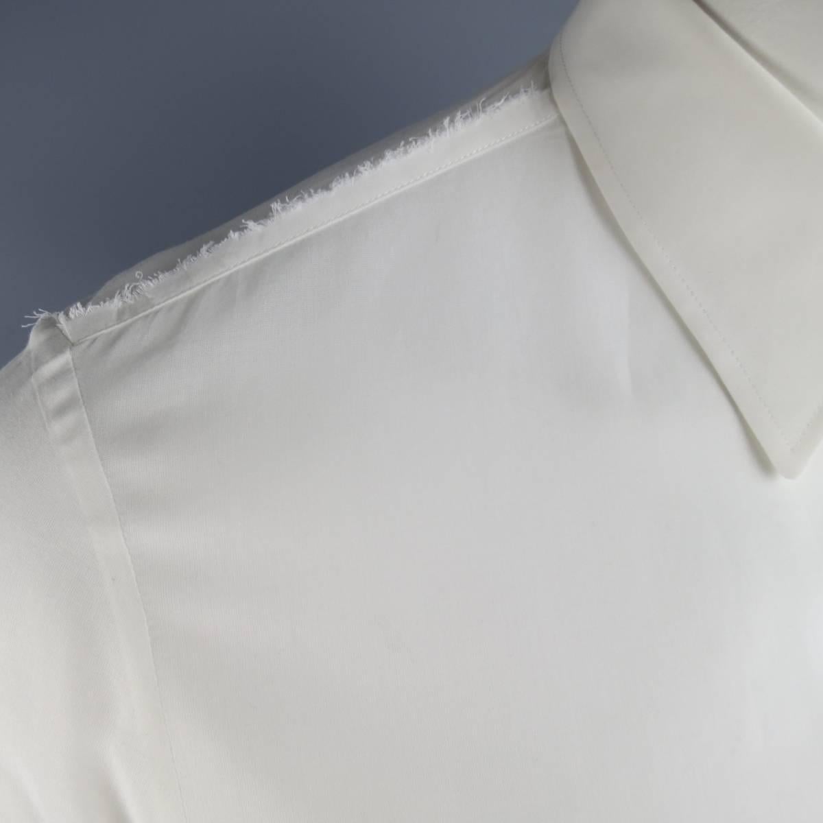 Light weight MAISON MARTIN MARGIELA dress shirt in an ultra sheer white cotton material featuring a pointed collar, cut off faux pocket applique, and frayed edge trim details. Made in Italy.
 
Excellent Pre-Owned Condition.
Marked: III
