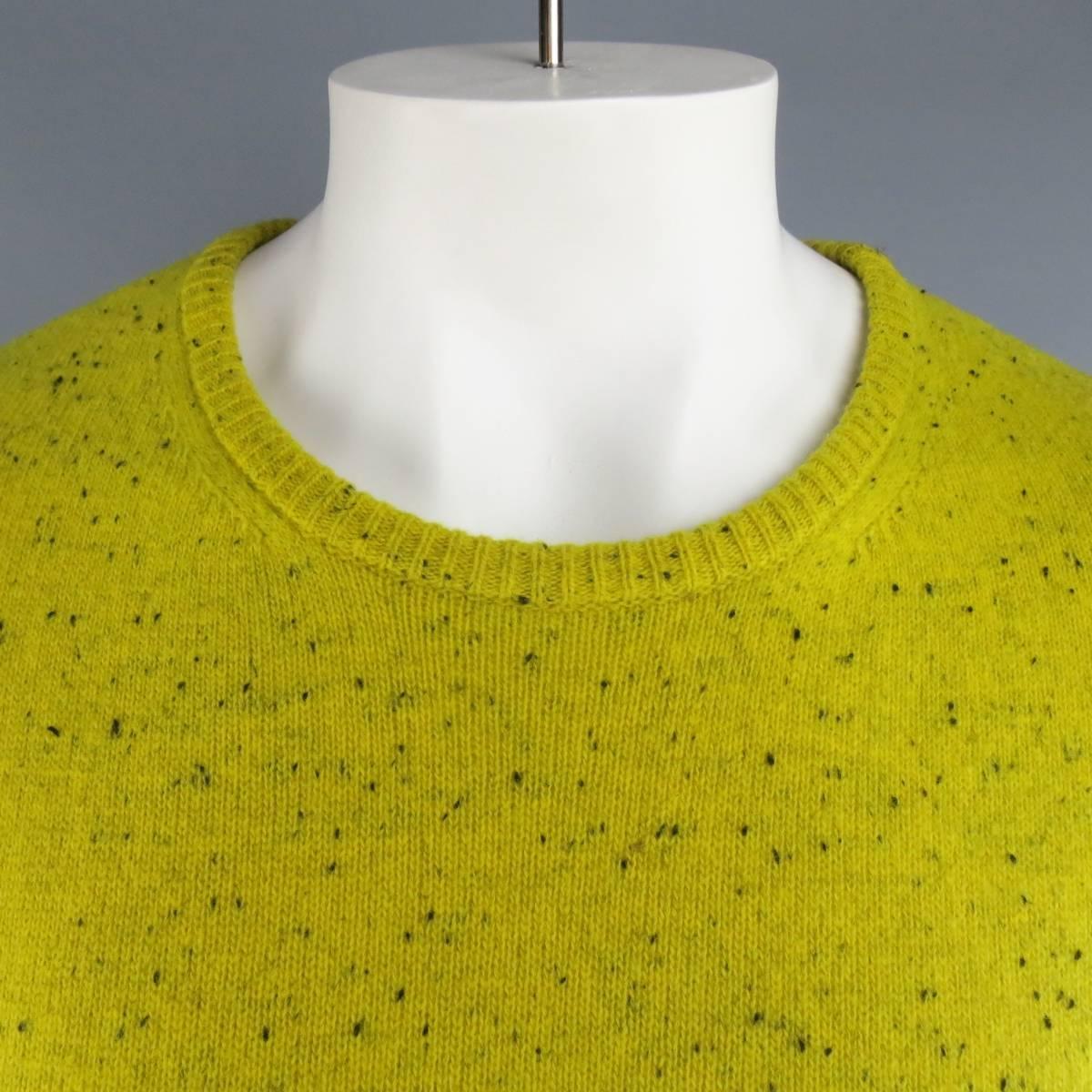RAF SIMONS crewneck pullover sweater in a black speckled chartreuse yellow marino wool knit featuring ribbed cuffs and a cable textured back panel. Made in Italy.
 
Excellent Pre-Owned Condition.
Marked: XL
 
Measurements:
 
Shoulder: 20 in.
Chest: