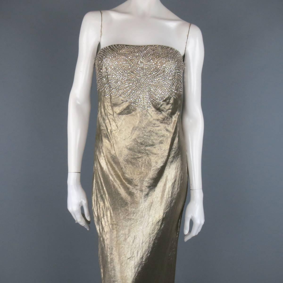 This stunning RALPH LAUREN COLLECTION strapless evening gown comes in a textured metallic silk blend material and features a built in bustier and beaded rhinestoned panel. Minor discoloration on back. Made in USA.
 
New with Tags.
Marked:
 
Bust: 