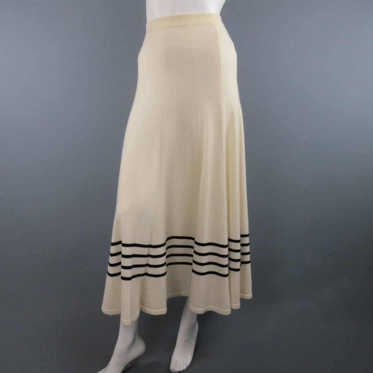 CHANEL midi skirt in a soft creamy beige cashmere featuring a long A line silhouette and nautical stripes. Matching cardigan available separately. Made in Italy.
 
Excellent Pre-Owned Condition.
Marked: IT 38
 
Measurements:
 
Waist: 26 in.
Hip: 38