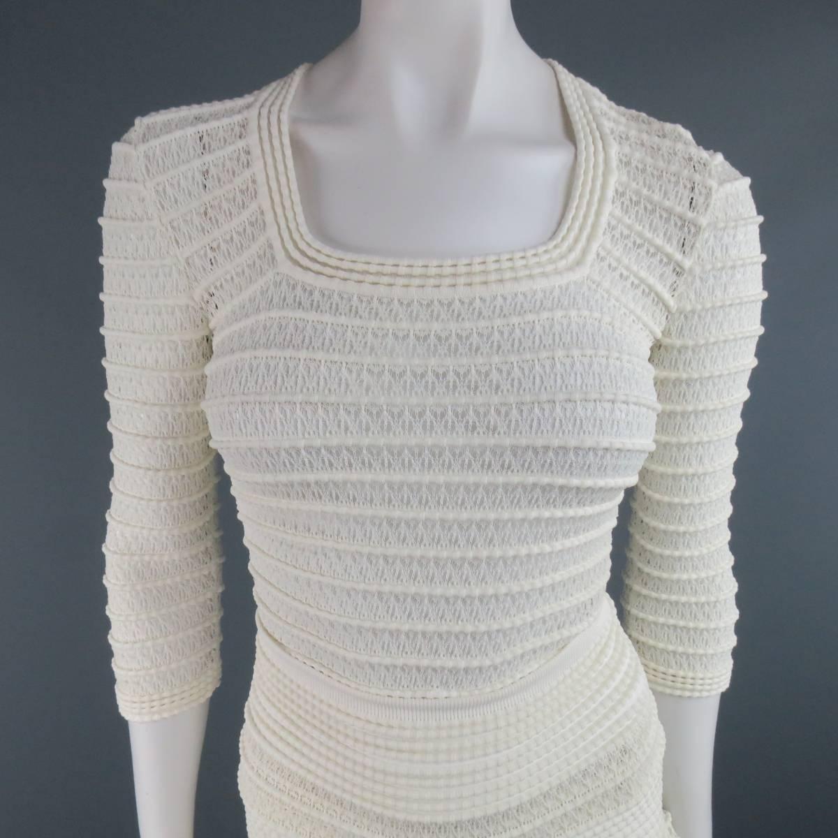 ALAIA skirt set in a creamy beige stripe textured viscose cotton mesh stretch knit includes a fitted, three quarter sleeve, scoop neck top and matching high rise, ruffled skirt. Made in Italy.
 
Excellent Pre-Owned Condition.
Marked: Top M, Skirt