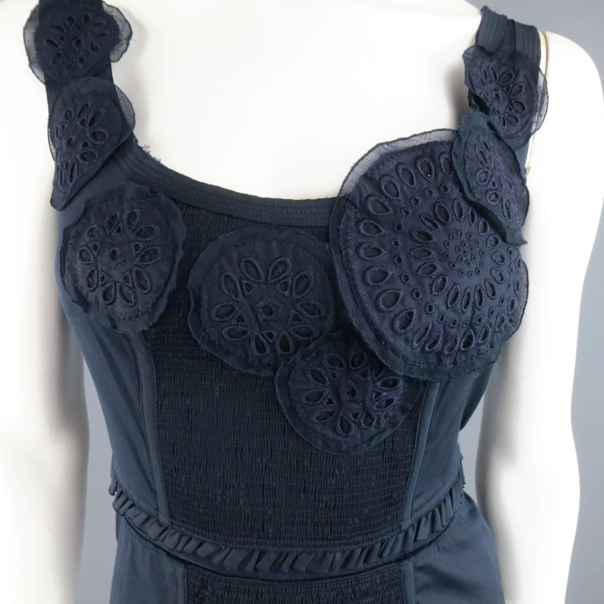 PRADA navy blue stretch cotton sleeveless tank blouse features a textured stretch front panel, embroidered appliques, pleated waist band,  and side zipper closure. Made in Italy.
 
Excellent Pre-Owned Condition.
Marked: 40 IT
 
Measurements:
 
Bust: