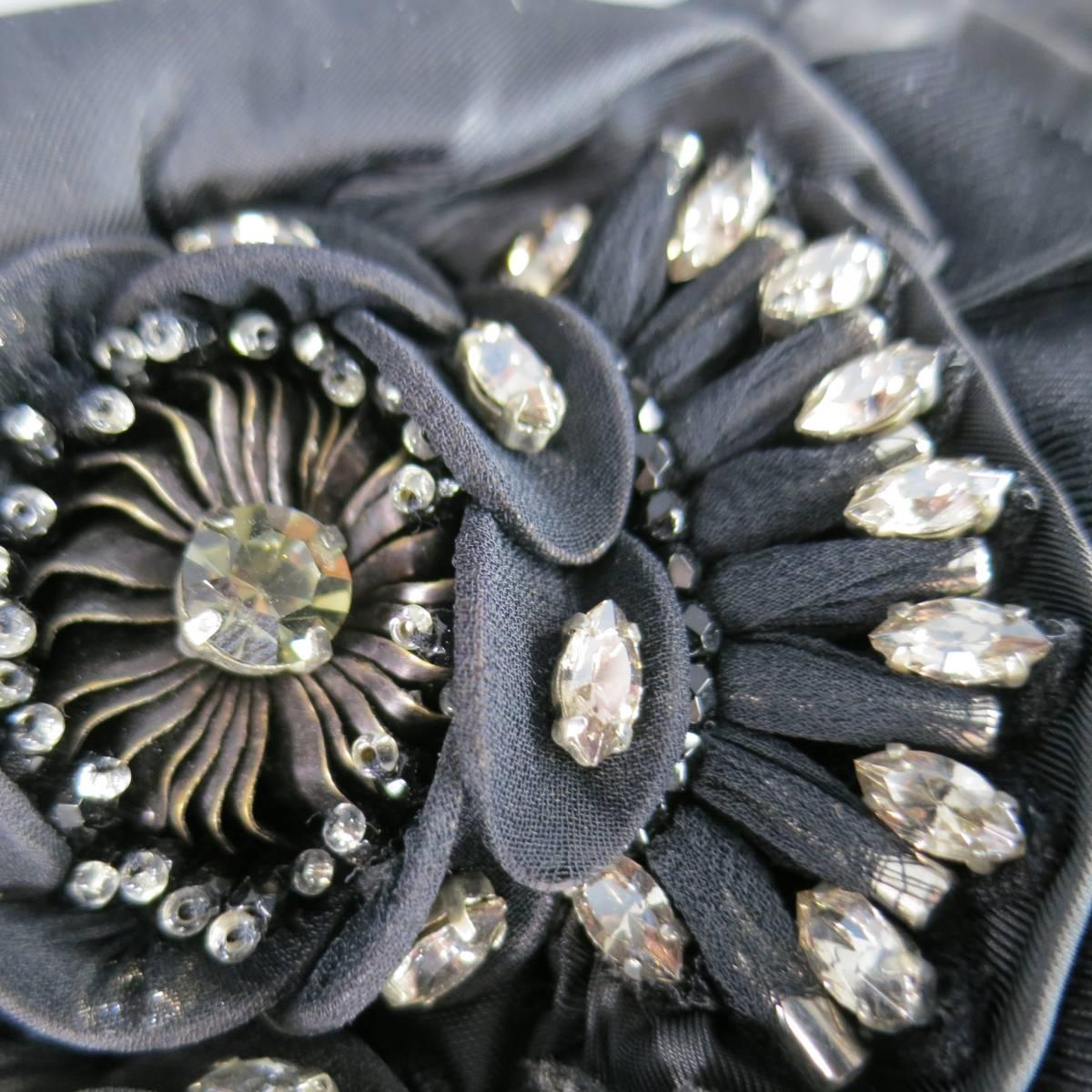 This lovely ELIE TAHARI clutch bag comes in black matte nylon with a gathered top zip closure, and ruffled ribbon and satin details with gorgeous rhinestone crystal flower embellishments.
 
Brand New Condition.
 
Measurements:
 
Length: 14