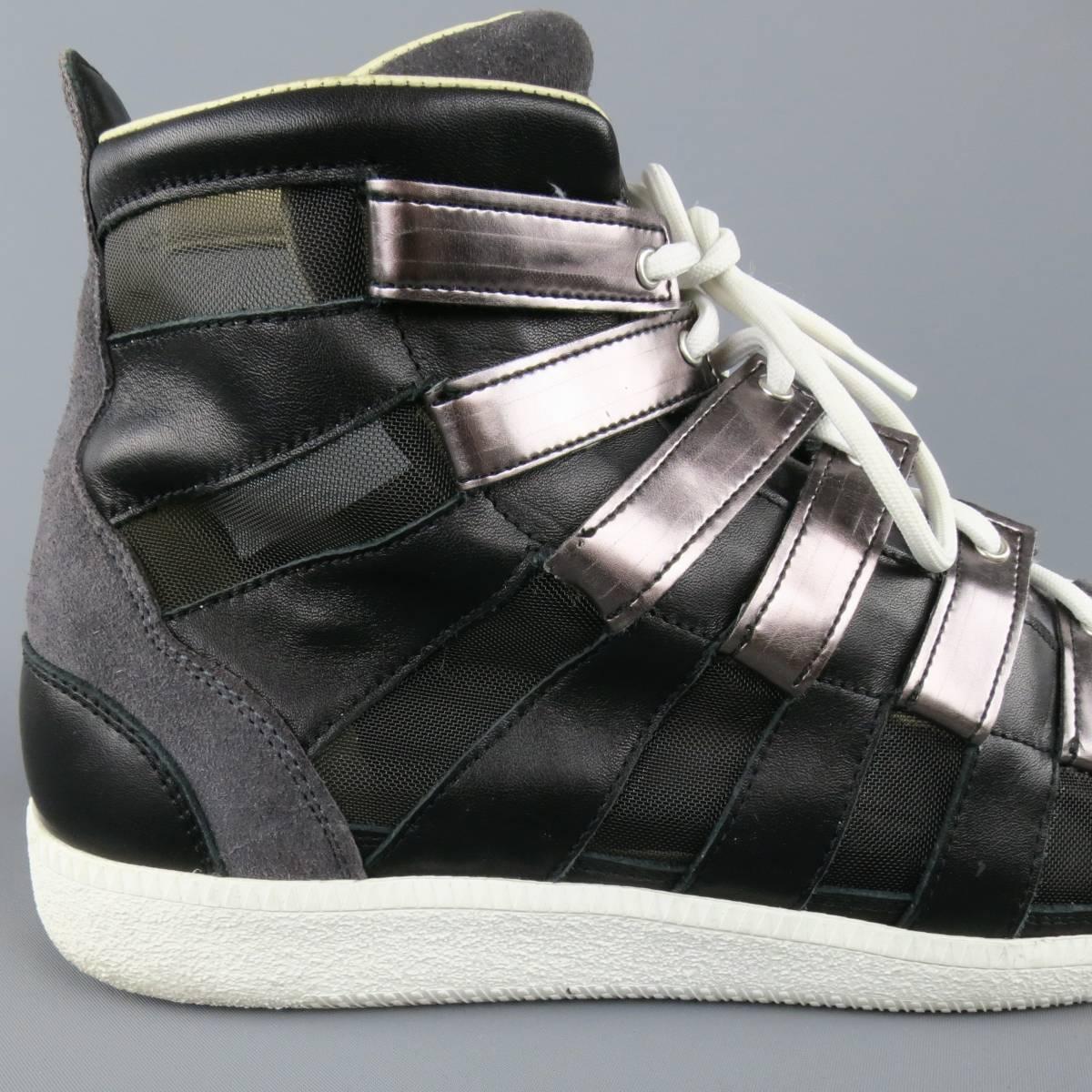 MAISON MARTIN MARGIELA high top sneakers feature black leather and mesh stripe paneled sides, charcoal suede toe, smoke silver metallic leather tab lace up front, and white rubber sole. Made in Italy.
 
Excellent Pre-Owned Condition.
Marked: IT