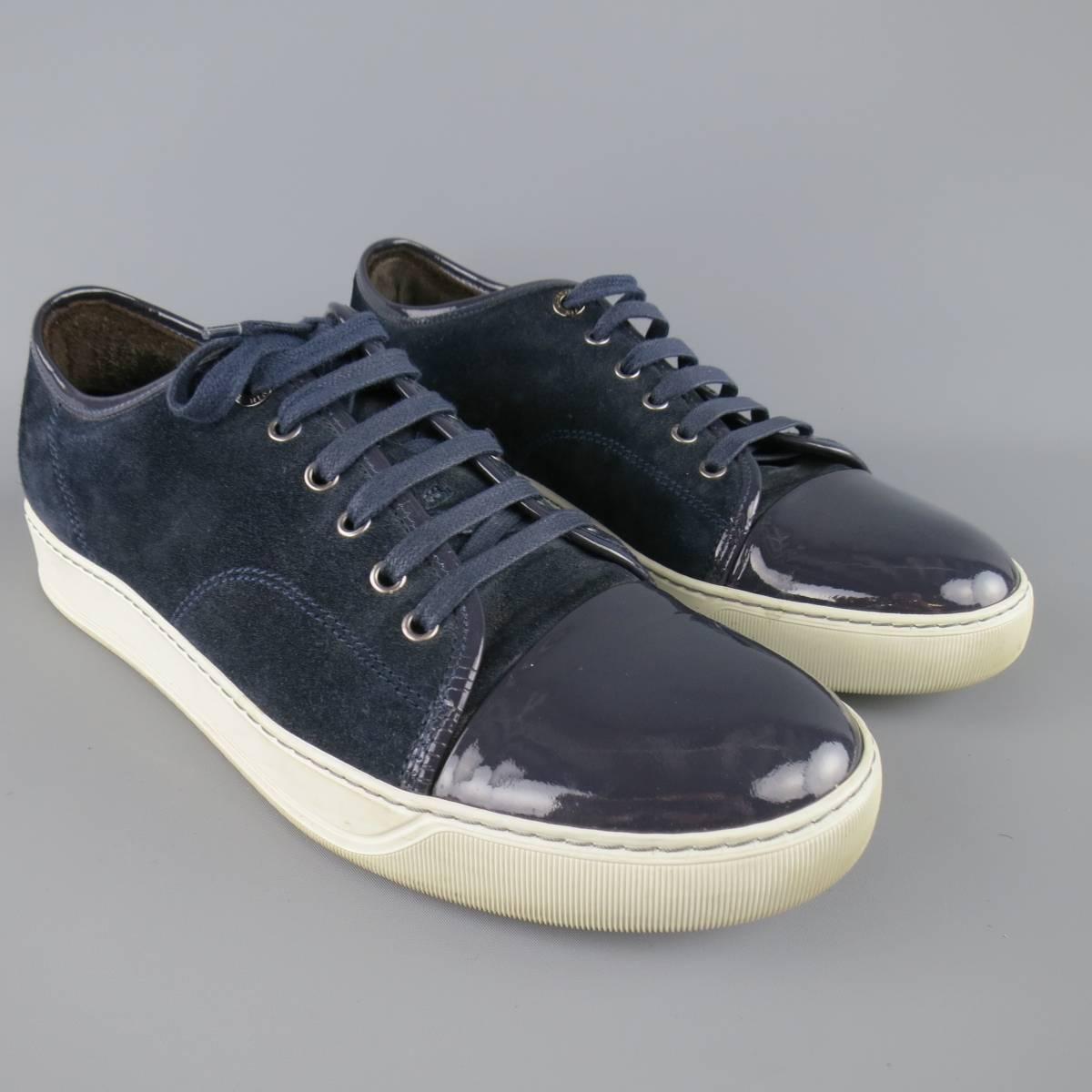 Classic LANVIN sneakers in a navy blue suede featuring a patent leather cap toe and thick white sole. Wear on sole. Made in Portugal.
 
Good Pre-Owned Condition.
Marked: UK 9
 
Outsole: 12 x 4.25 in.