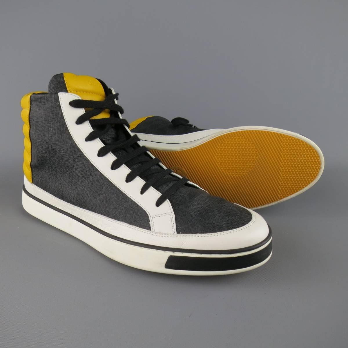 Limited Edition GUCCI high top sneakers come in a navy and charcoal monogram fabric with white leather trim, yellow leather padding and rubber sole. Minor Wear. Made in Italy.
 
Good Pre-Owned Condition.
Marked: UK 12.5
 
Outsole: 12.5 X 4.5