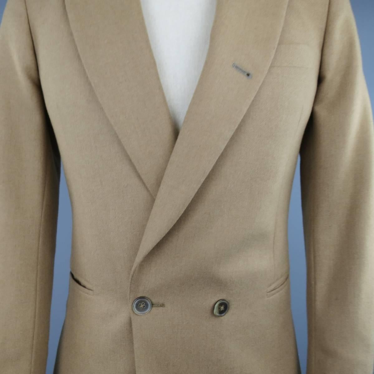 PAUL SMITH Sport Coat consists of camel hair material in a tan color tone. Designed in a double-breasted, peak lapel collar and single button front. Top pocket square and bottom inseam pockets. 4-button cuffs, double back vent and full lining. Made
