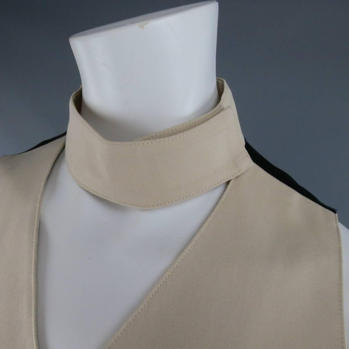 JUNIOR GAULTIER by JEAN PAUL GAULTIER beige wool vest features a velcro neck tab, v-neck cut with button closure, slit pockets, black panel with tab adjustment in the back. Made in Japan.
 
Good Pre-Owned Condition.
Marked: 40
 
Measurements:
