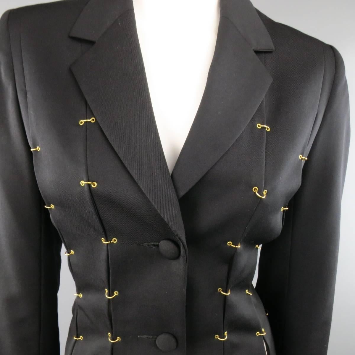 Vintage M. YOKO black wool blazer features notch lapel, three button closure, and slit construction with gold pierced hoop grommets.
 
Excellent Pre-Owned Condition.
Marked: S
 
Measurements:
 
Shoulders: 30 In.
Bust: 37 In.
Sleeve: 23 In.
Length: