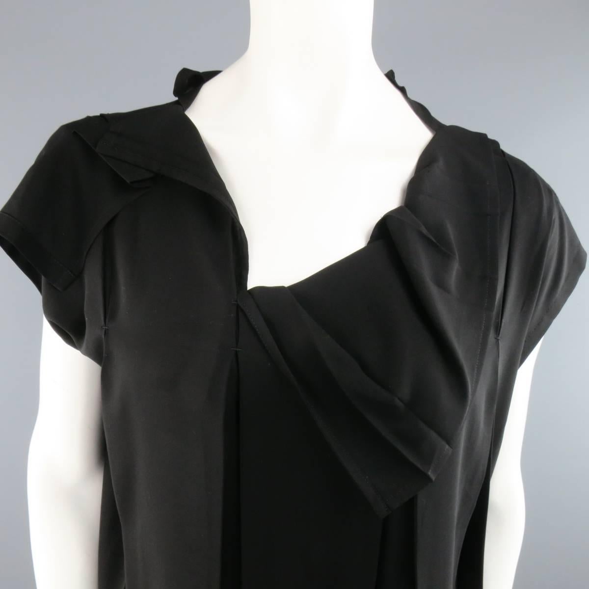 ISSEY MIYAKE black chiffon blouse features asymmetrical pleating details throughout and mock cap sleeves. Made in Japan.
 
Excellent Pre-Owned Condition.
Marked: 3
 
Measurements:
 
Shoulders: 35 In.
Bust: 49 In.
Length: 25 In.