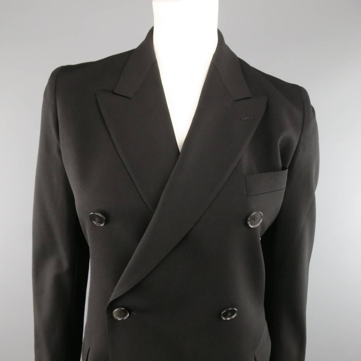 JEAN PAUL GAULTIER double breasted blazer comes in a black wool twill and features a peak lapel, flap pockets, pointed hem, functional button cuffs, belt loops at waist, and beige printed liner. Made in Italy.
 
Excellent Pre-Owned