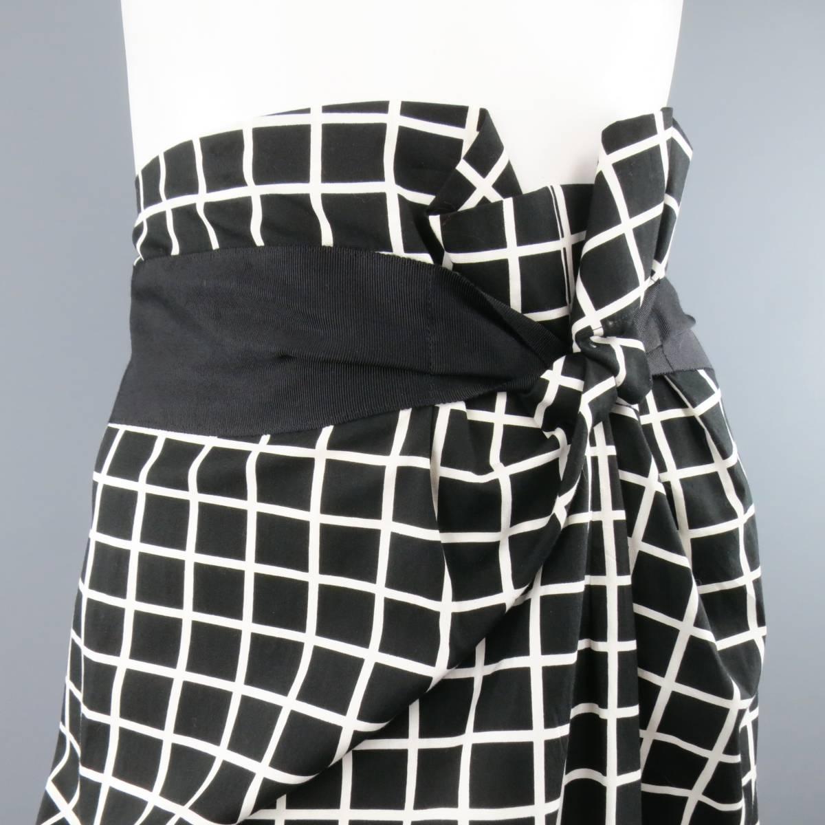 DRIES VAN NOTEN black and white windowpane cotton skirt features an asymmetrical draped front with a solid black ribbon waist and zipper closure in the back. Made in Belgium.
 
Excellent Pre-Owned Condition.
Marked:  38
 
Measurements:
 
Waist: 32