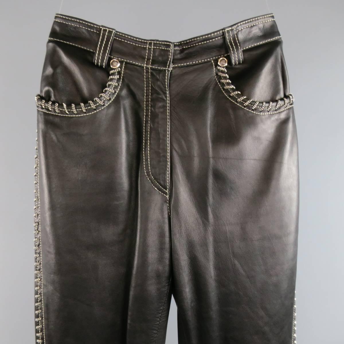 Vintage GIANNI VERSACE black leather pants feature all-over white white stitching and chain link detailing, zipper fly closure, Medusa head rivets, zipper detailing at the hems and zipper flap pockets in the back. Partially lined. With Tags. Made in