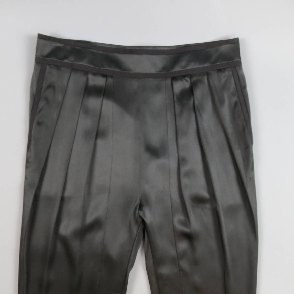 GIVENCHY back silk satin pants feature a pleated front, waistband with piping, riding pant details, drop crotch, and tapered leg with snap tab cuff. Made in Italy.
 
Excellent Pre-Owned Condition.
Marked: 44
 
Measurements:
 
Waist: 35 In.
Rise: