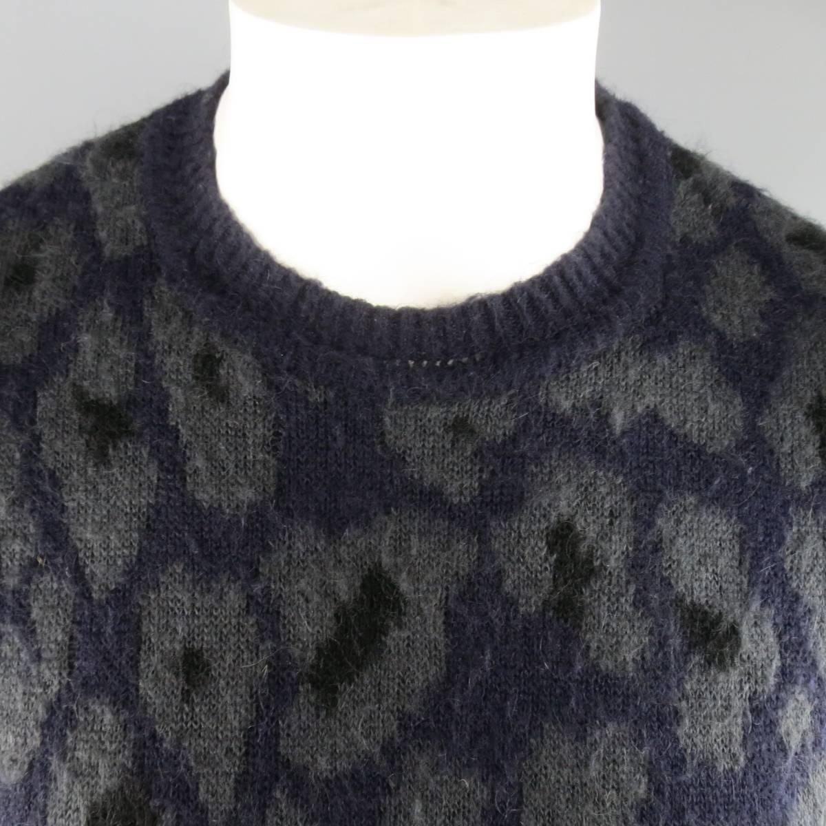 RAF SIMONS crewneck pullover sweater in a deep navy blue mohair blend fuzzy knit with all over charcoal cheetah leopard print. Wear throughout. Made in Italy.
 
Good Pre-Owned Condition.
Marked: S
 
Measurements:
 
Shoulder: 16.5 in.
Chest: 40