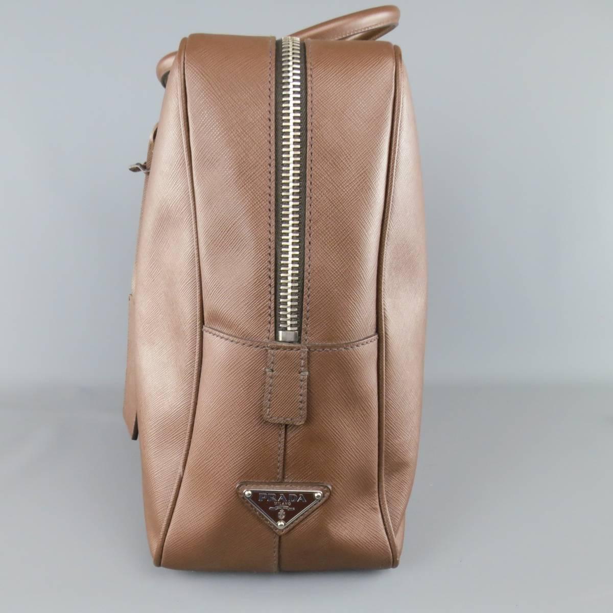Classic rectangular PRADA briefcase in a light brown Seffiano textured leather featuring a thick silver tone zip top closure with side lock, double covered top handles, luggage tag, and internal storage. Wear throughout. with dust bag. As-Is. Made