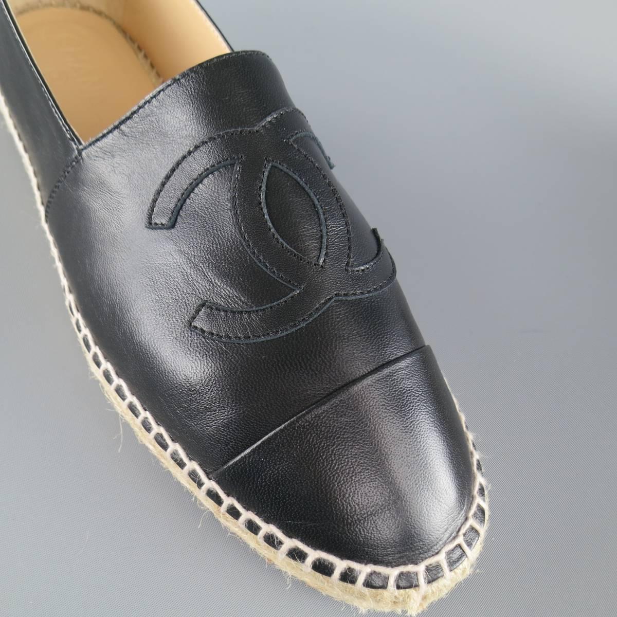 CHANEL espadrilles in a soft black lamb skin leather featuring a cap toe, CC logo and tan woven mid with rubber sole. With box. Made in Spain.
 
Excellent Pre-Owned Condition.
Marked: IT 42
 
Outsole: 11 x 3.25 in.