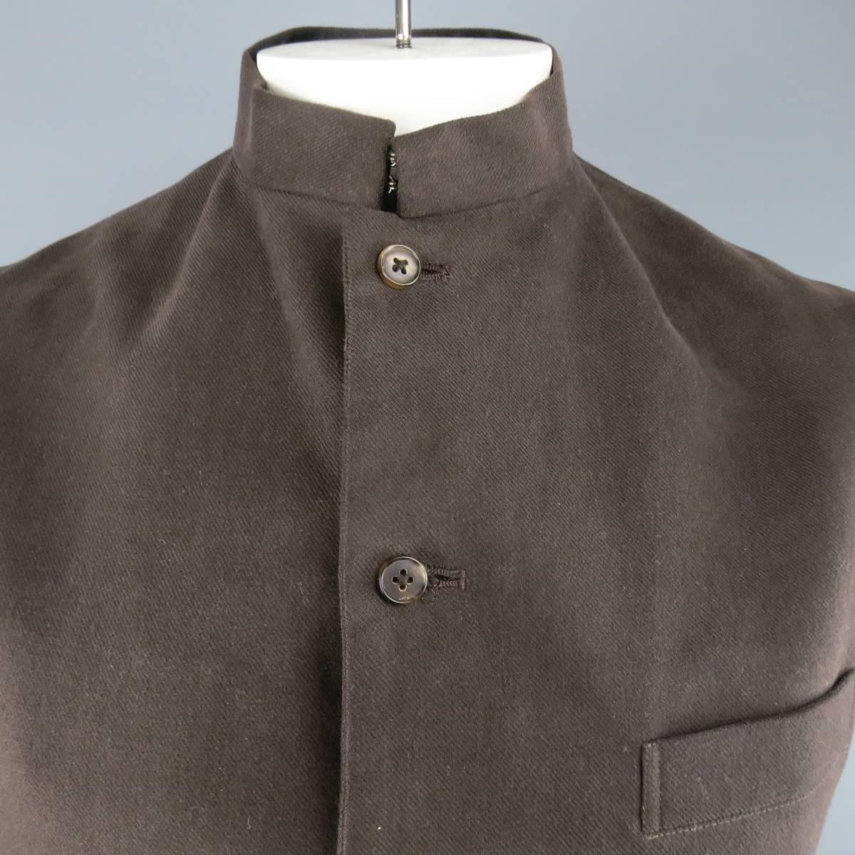 Y'S BY YOHJI YAMAMOTO vest in a brown cotton twill featuring a button up front and nehru band collar with hook eye closures. Made in Japan.
 
Excellent Pre-Owned Condition.
Marked: L
 
Measurements:
 
Shoulder: 16.5 in.
Chest: 42 in.
Length: 28 in.