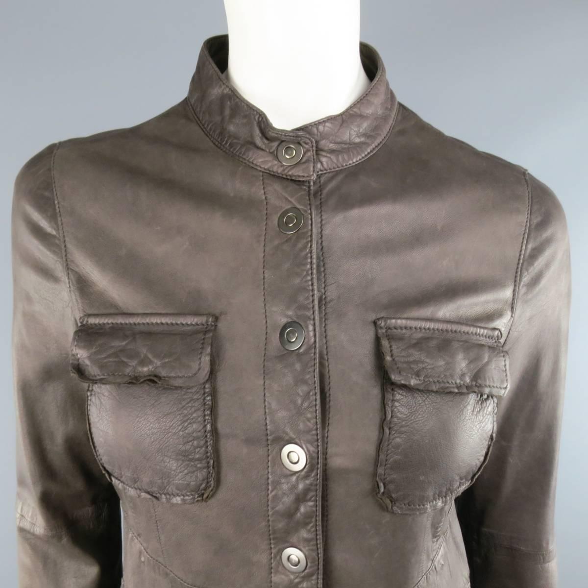 EMPORIO ARMANI fitted military jacket in a soft distressed taupe leather featuring a nehru band collar, snap closure, patch pockets, and ruffled back. Belt removed, very small holes along waist. As-Is.
 
Fair Pre-Owned Condition.
Marked: 6
