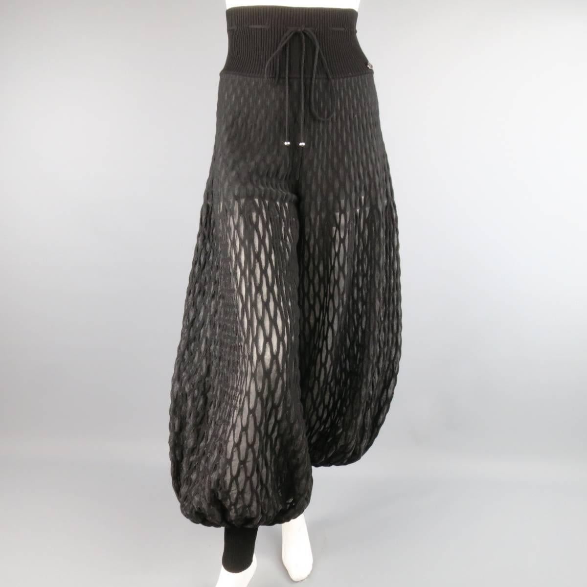 CHANEL high rise, drop crotch harem style pants come in a sheer net pattern knit and feature a dramatic balloon leg, thick ribbed knit waist and ankle bands, and gunmetal tone detail at waist.
Semi-opaque through upper portion. Made in Italy.
