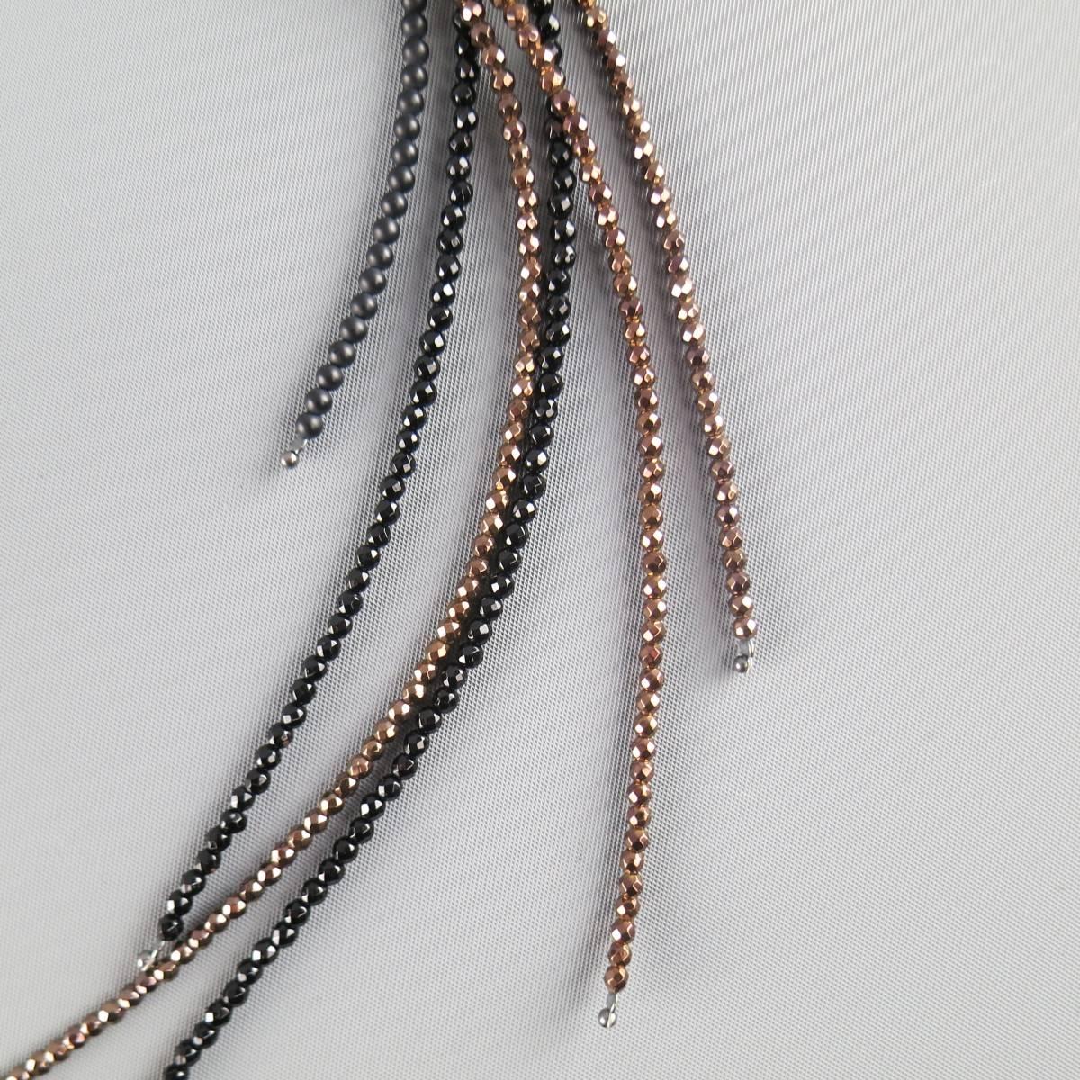 BRUNELLO CUCINELLI comes in  black and bronze metallic and matte beaded strands and features a looped side with dark sterling silver closure and long fringe that is worn through the loop. Made in Italy.
 
Excellent Pre-Owned Condition.
Marked: