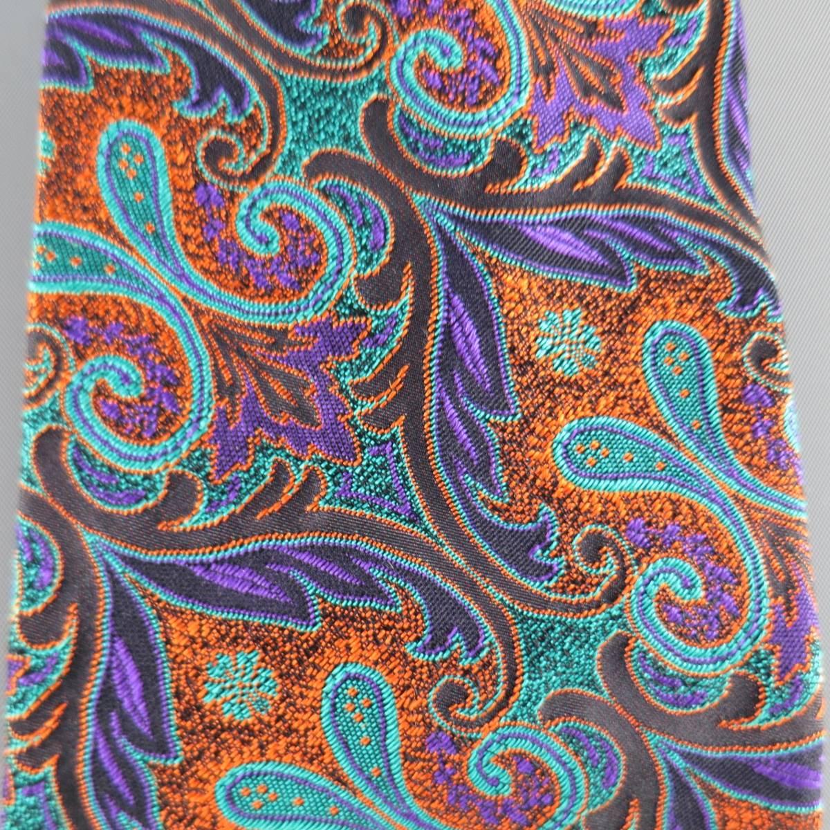 GIANNI VERSACE Vintage Tie consists of 100% silk material in a teal and orange color tone. Designed in a modern style, paisley brocade pattern with multi-color accents. Comes with original boxing. Made in Italy .
 
Good Pre-Owned