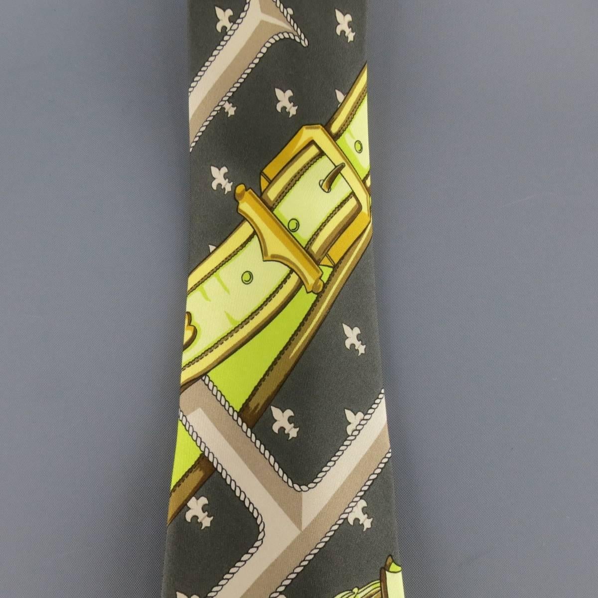 Vintage HERMES tie in a fleur de lis charcoal gray silk twill featuring a scarf print with oversized H's, and lime green and gold brocade and belt panels. Small stains on side. Made in France.
 
Fair Pre-Owned Condition.
 
Width: 4 in.