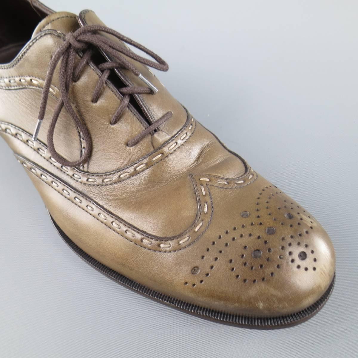BOTTEGA VENETA lace ups in a washed olive leather featuring a wingtip toe, top stitching, and brogue details throughout. Wear throughout leather. Made in Italy.
 
Fair Pre-Owned Condition.
Marked: IT 42.5
 
Outsole: 11.75 x 4 in.