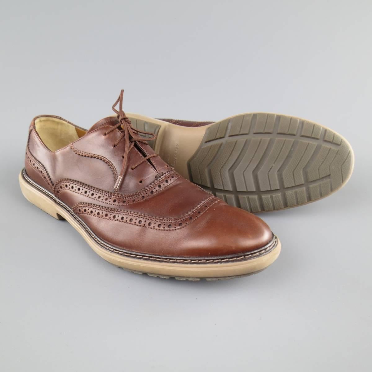 SALVATORE FERRAGAMO lace ups in a tan brown leather featuring perforated brogue details throughout and a tan rubber sole. Wear throughout leather. Made in Italy.
 
Good Pre-Owned Condition.
Marked:11
 
Outsole: 13 x 4.75 in.