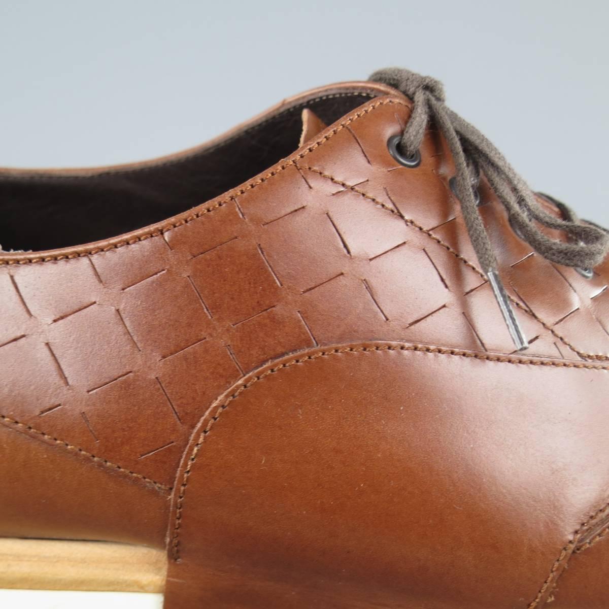 SALVATORE FERRAGAMO lace ups come in a tan smooth leather and feature a slit checkered pattern panel, wingtip toe, and off white rubber sole. Wear throughout. As-Is. Made in Italy.
 
Fair Pre-Owned Condition.
 
Outsole: 12.75 x 4.5 in.
