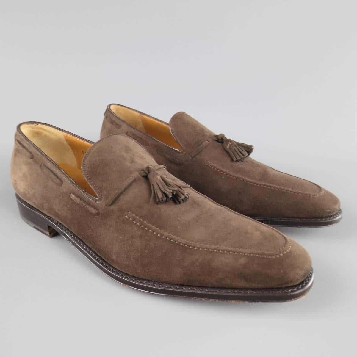 SALVATORE FERRAGAMO Loafers consists of suede material in a brown color tone. Designed with a pointed round-toe front, top tone-on-tone stitching and suede tassels. Leather sole with rubber heel. Made in Italy.
 
Excellent Pre-Owned Condition
Marked